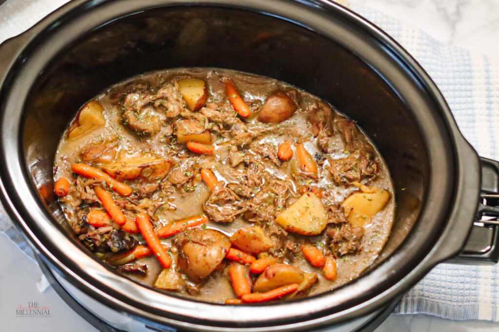 This slow cooker pot roast recipe features carrots, potatoes, and gravy and guarantees a melt-in-your-mouth pot roast with every serving.